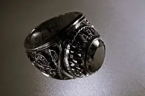 Handcrafted lucky rings and spiritual charms by Psychic Solo displayed on a dark ancestral cloth